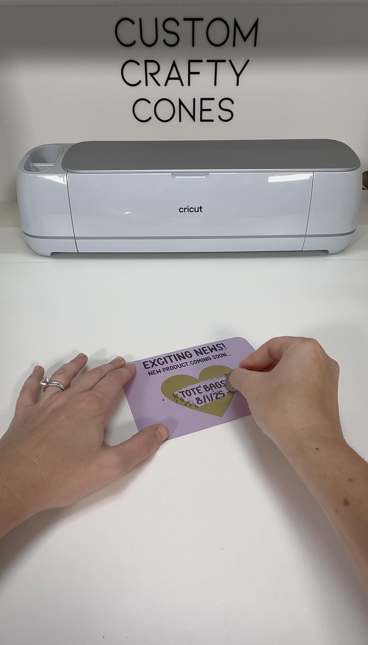 A scratch-off card being revealed by hand in Laura's studio